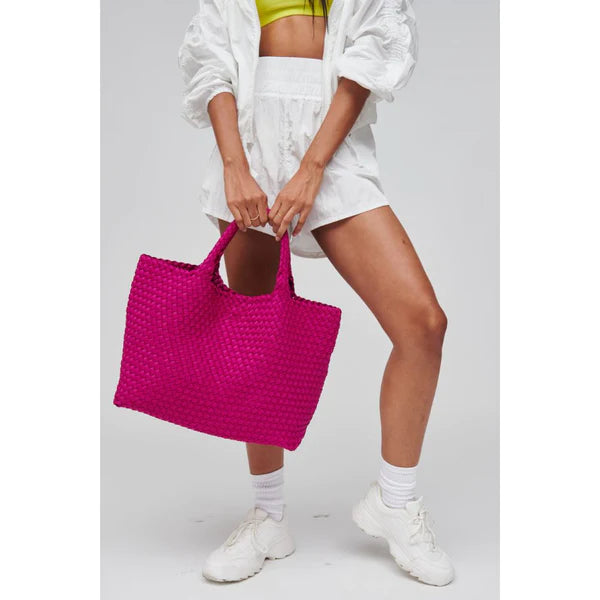 model carrying a hot pink tote bag