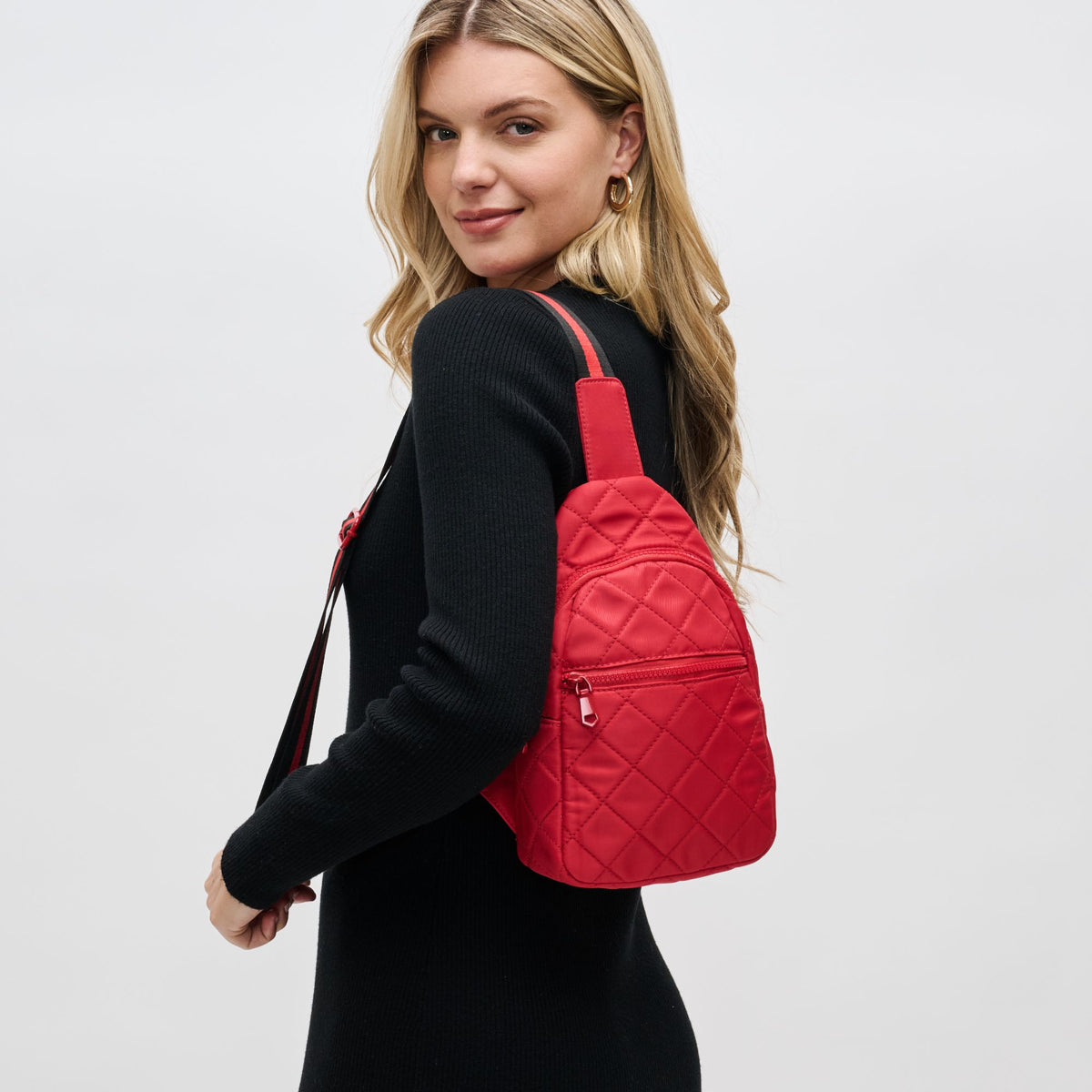 Woman wearing Red Sol and Selene Motivator Sling Backpack 841764107938 View 1 | Red