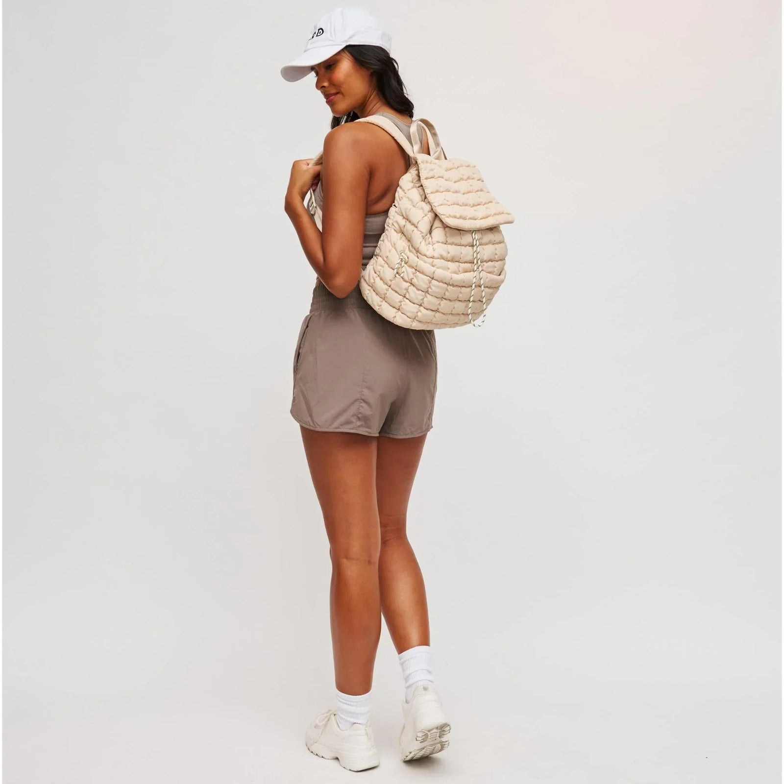 A woman wearing a bag with women’s travel accessories