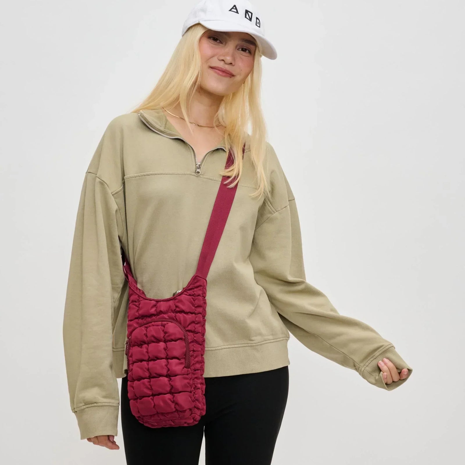 Woman with a red crossbody purse, one of the best camping bags