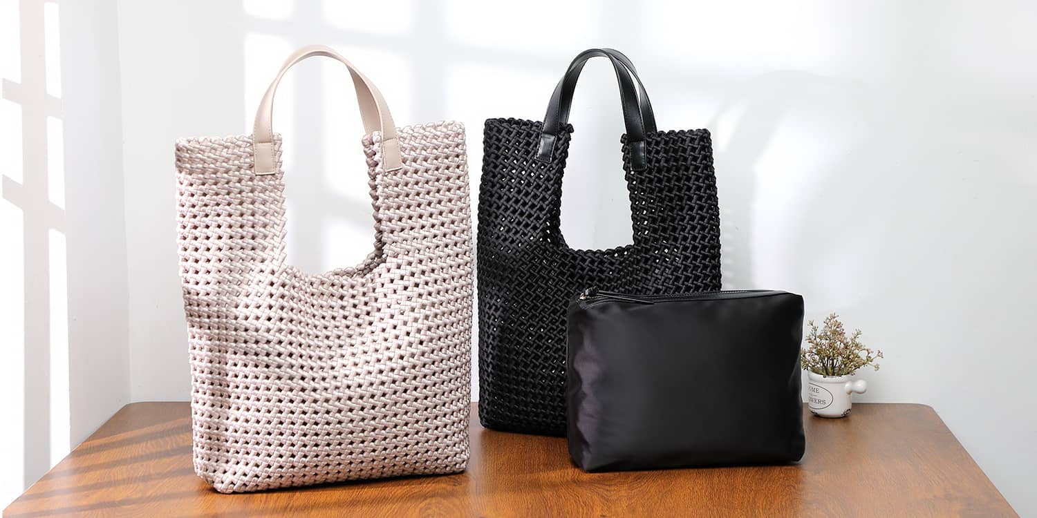 cream and black handbags on a table