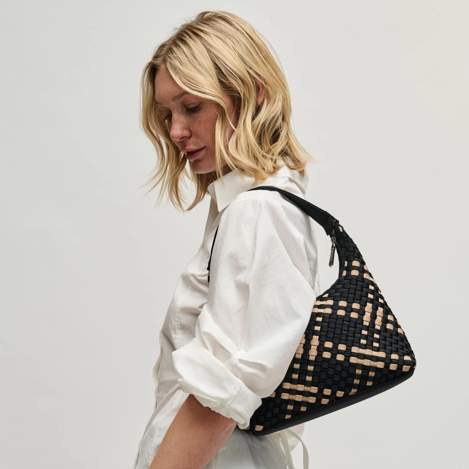 Woman carrying a black neoprene shoulder bag