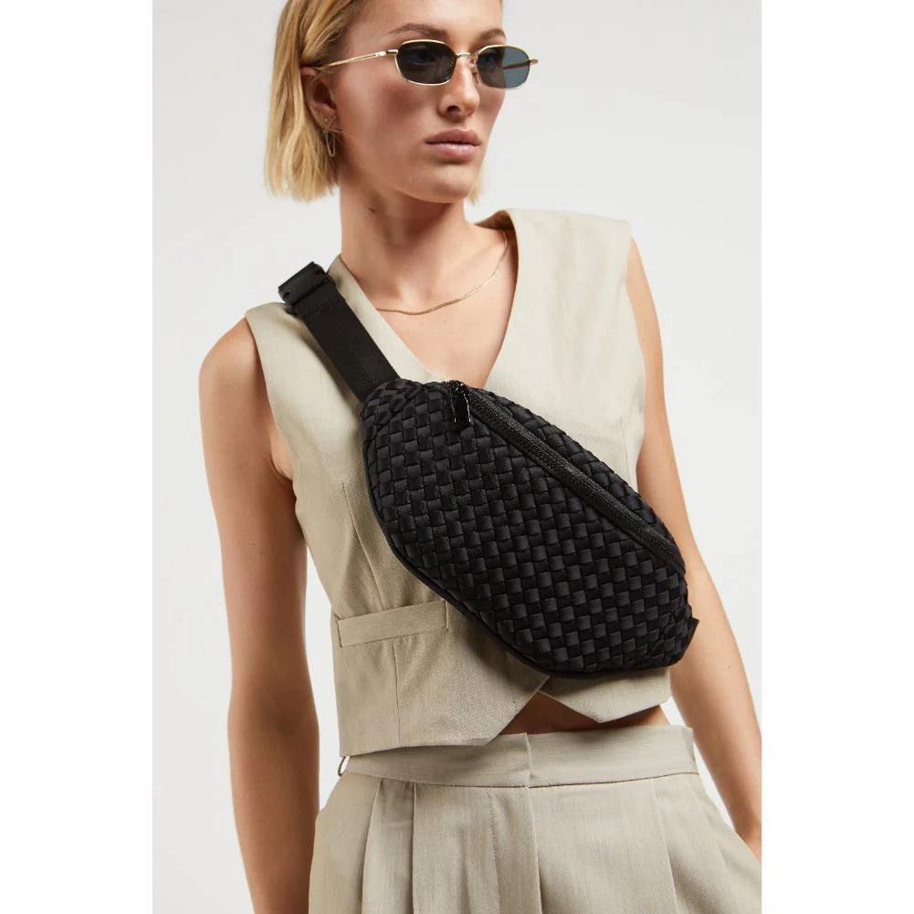 a model wearing Sol and Selene’s Aim High belt bag in woven neoprene