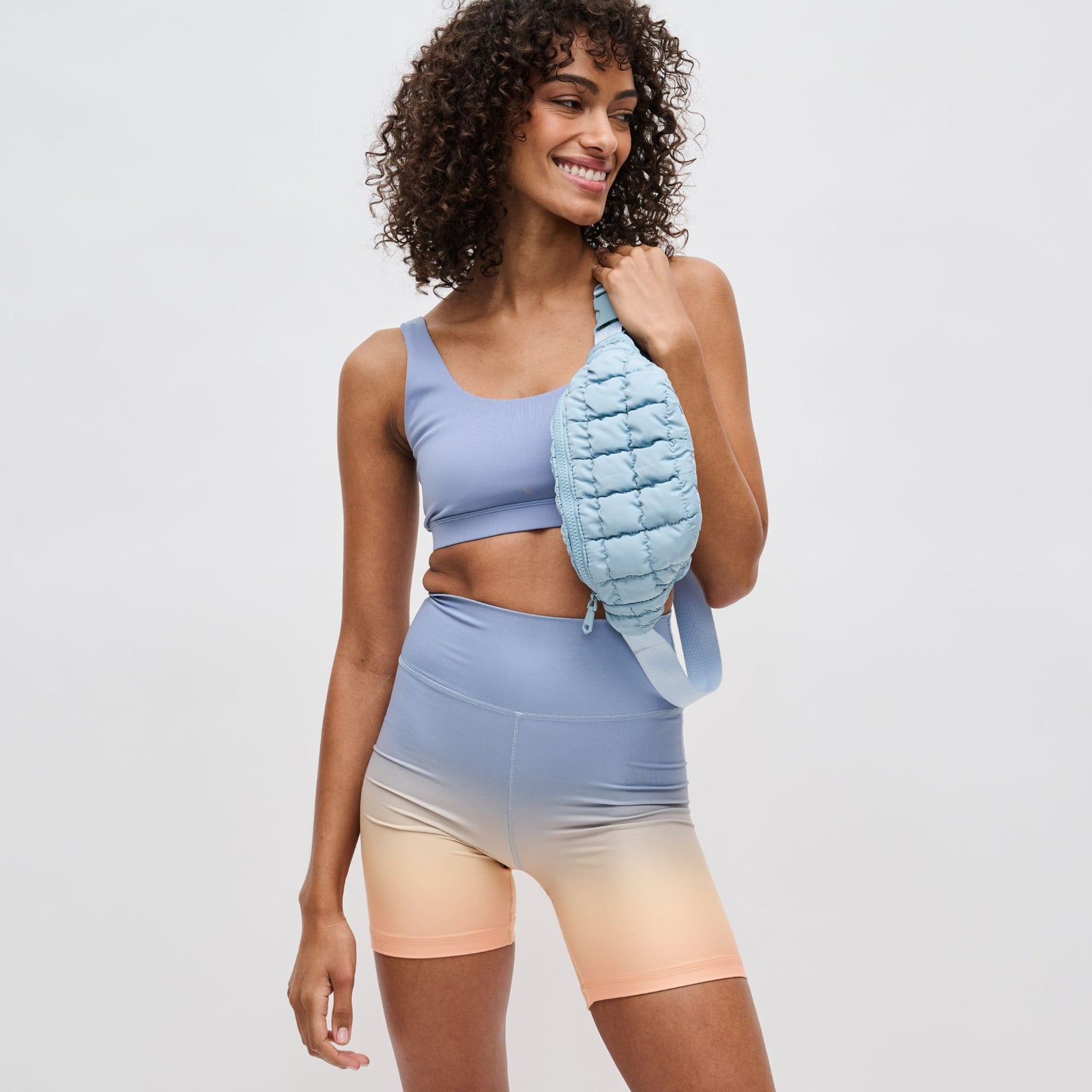 model wearing a blue belt bag