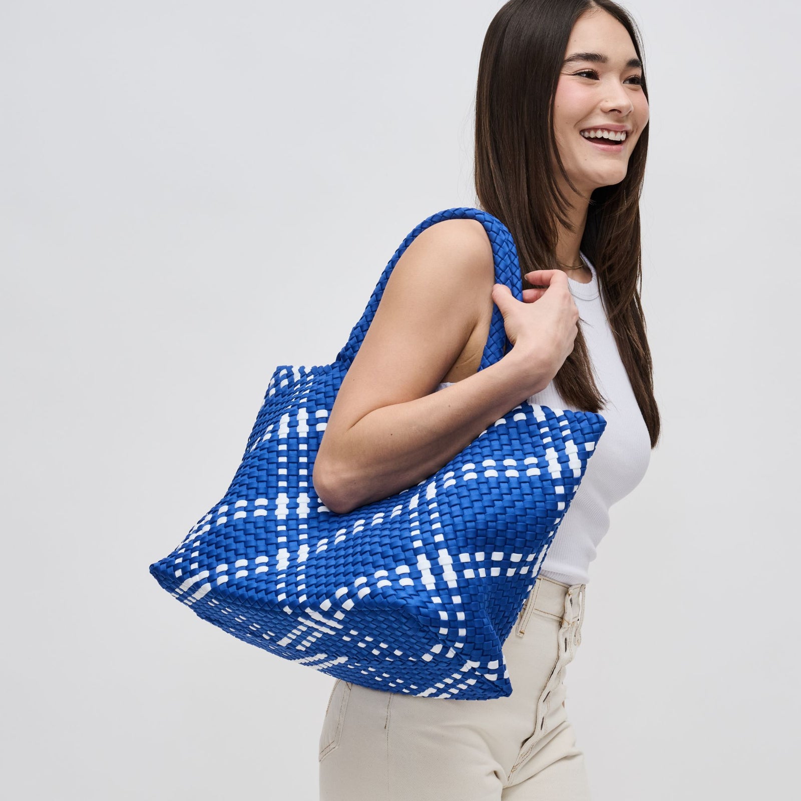 woman with a blue woven bag on her shoulder