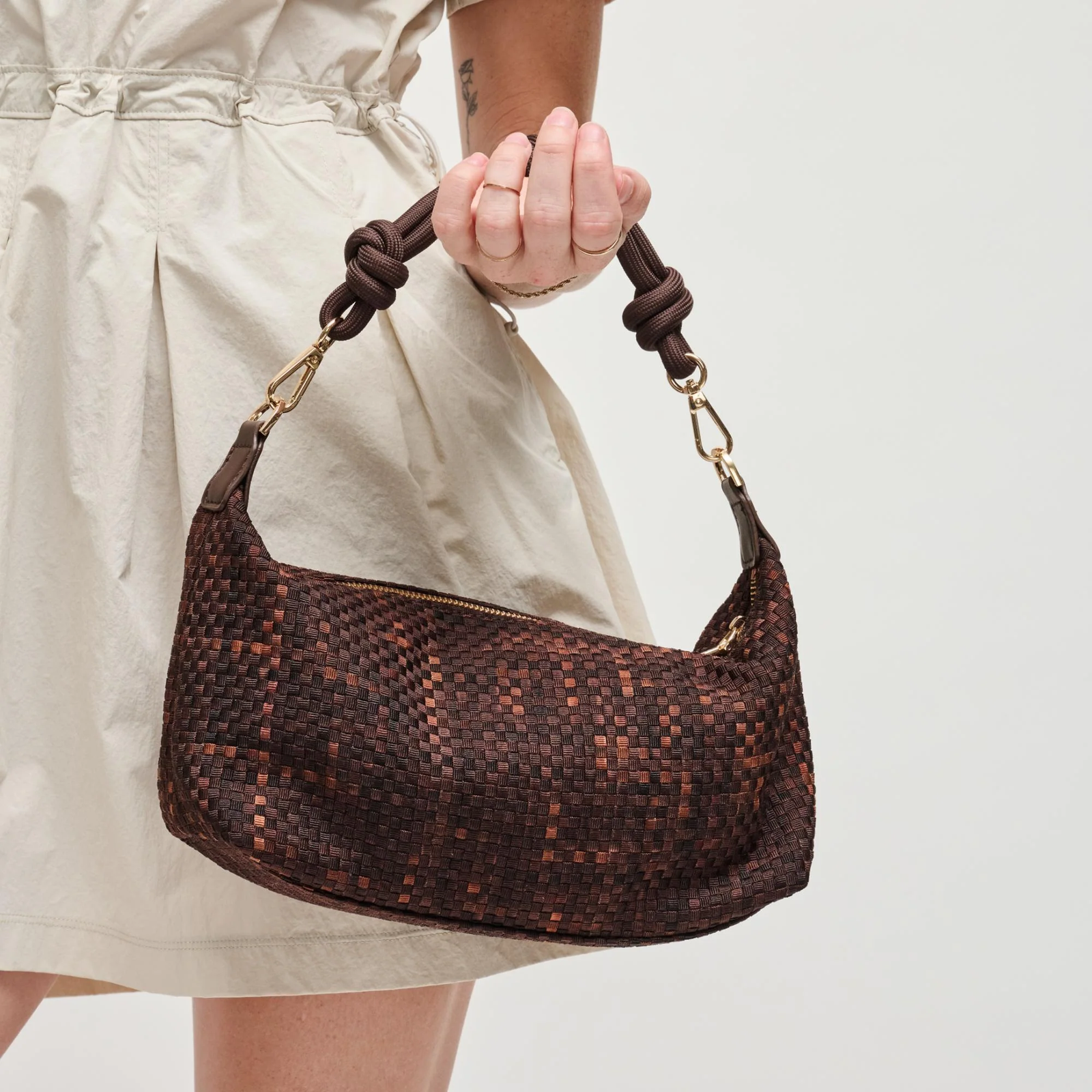 Woman holding a brown lightweight shoulder bag