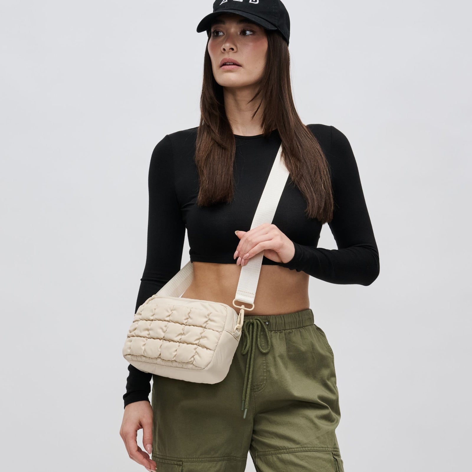 woman wearing a cream crossbody purse