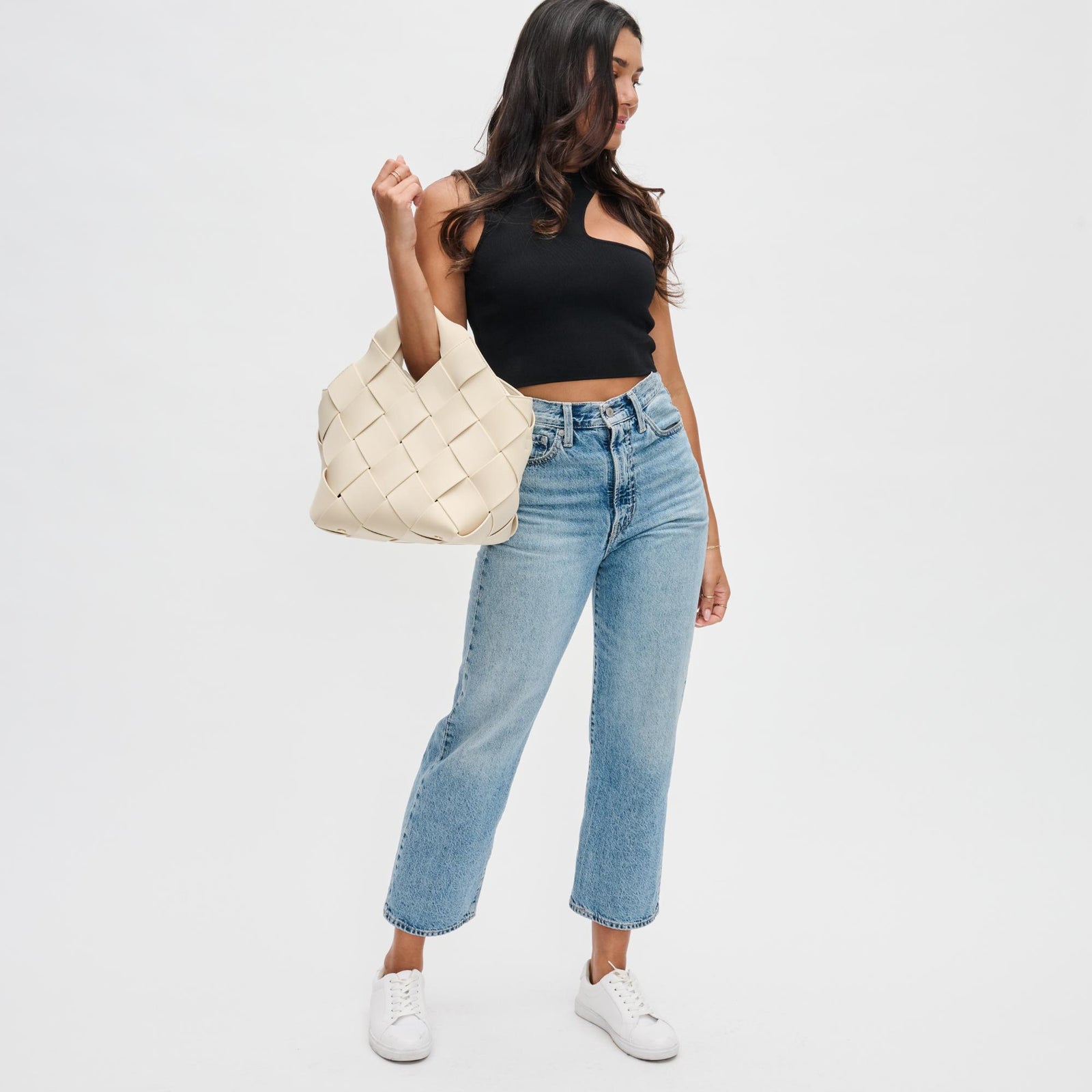 Woman carrying a cream day-to-night bag