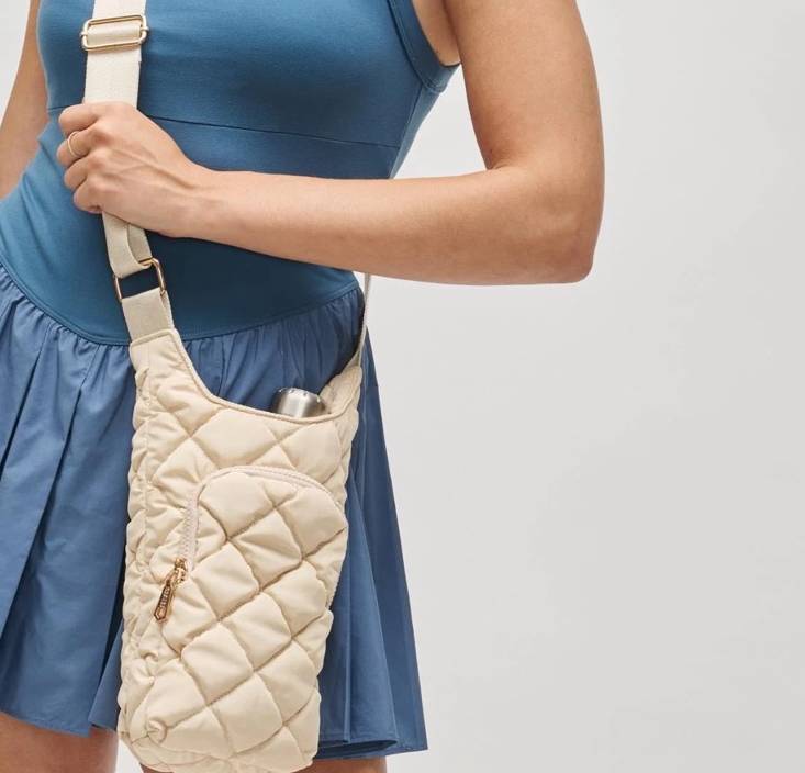 Close-up of a cream quilted crossbody bag