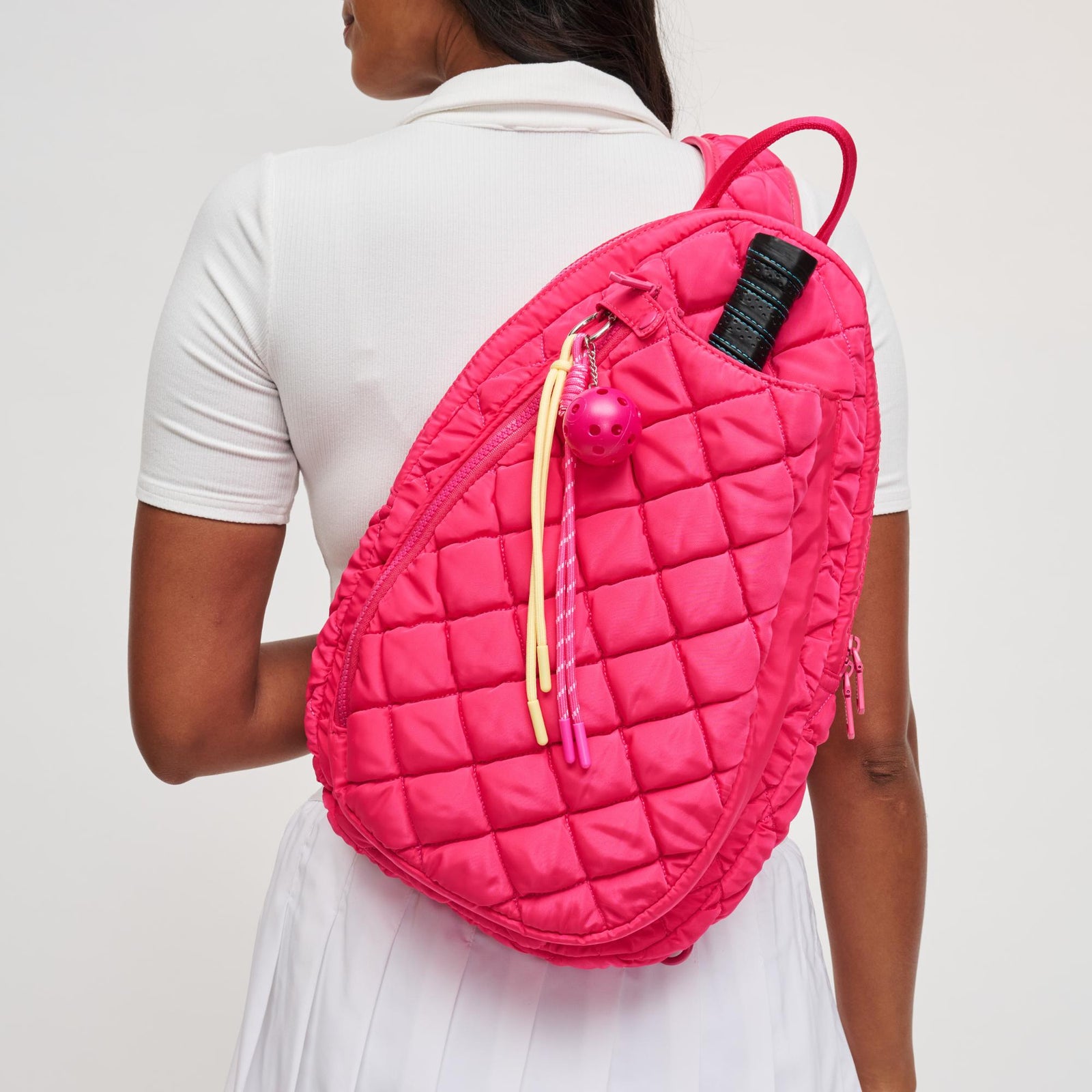 woman wearing a hot pink sling bag