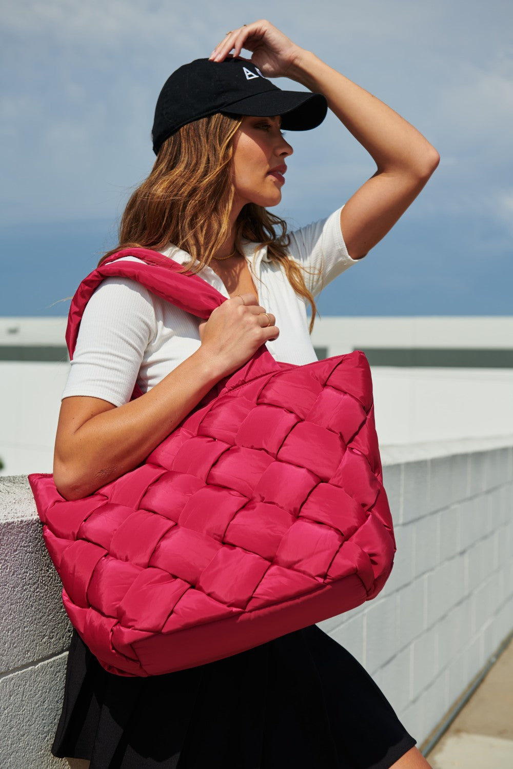 model carrying hot pink tote bag