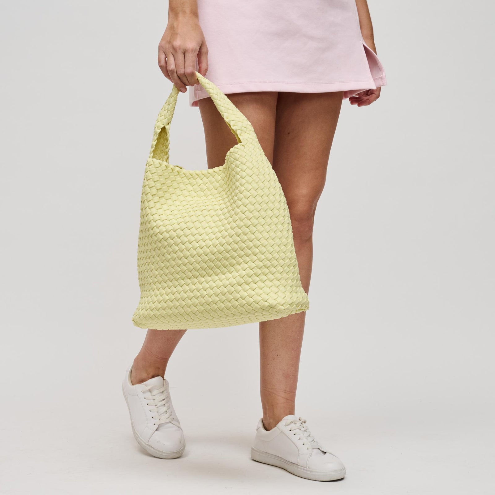 Woman carrying a lightweight yellow hobo bag