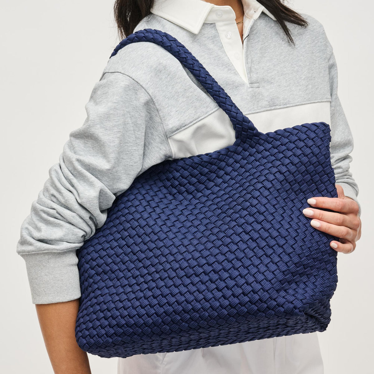 Woman wearing Navy Sol and Selene Sky's The Limit - Medium Laced Up Eco-Edition Tote 841764111614 View 1 | Navy