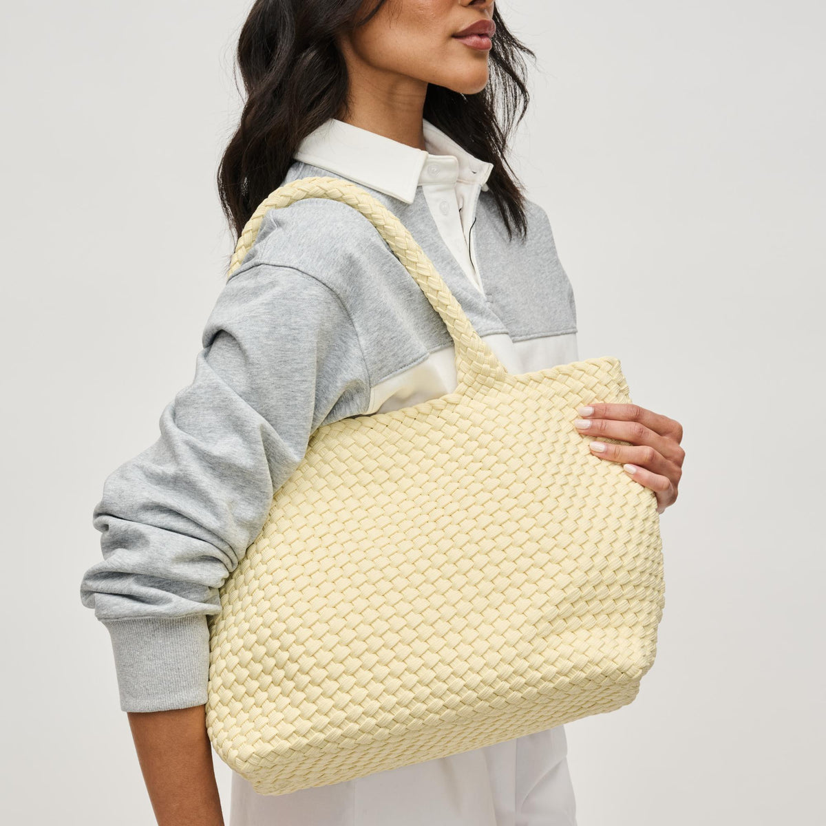 Woman wearing Butter Sol and Selene Sky's The Limit - Medium Laced Up Eco-Edition Tote 841764111607 View 1 | Butter