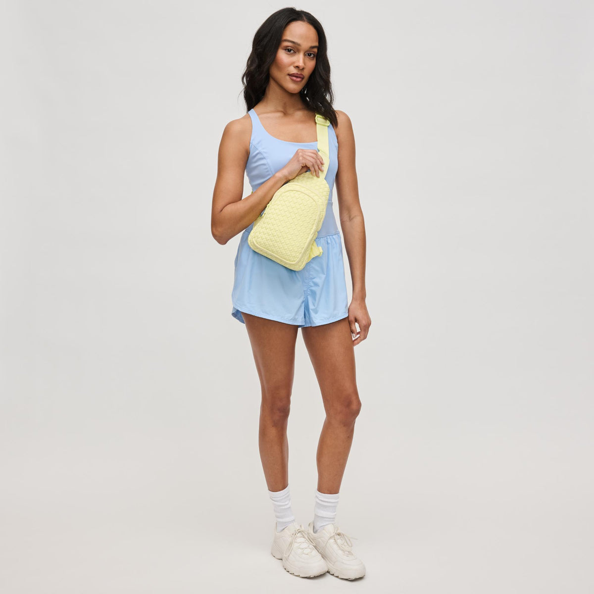 Woman wearing Butter Sol and Selene Beyond The Horizon - Woven Neoprene Sling Backpack 841764111225 View 4 | Butter