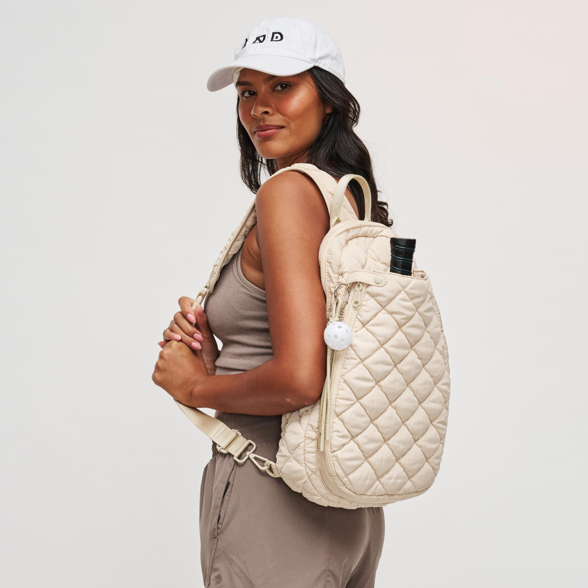 Woman wearing Cream Sol and Selene Match Point - Quilted Puffer Pickleball & Paddle Tennis Sling Backpack 841764111980 View 2 | Cream