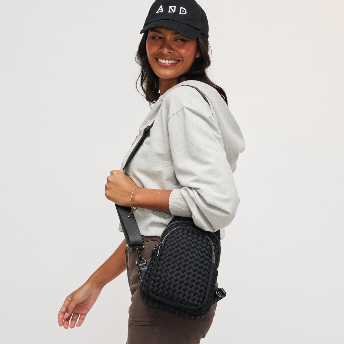 Woman wearing Black Sol and Selene Beyond The Horizon - Woven Neoprene Sling Backpack 841764108034 View 2 | Black