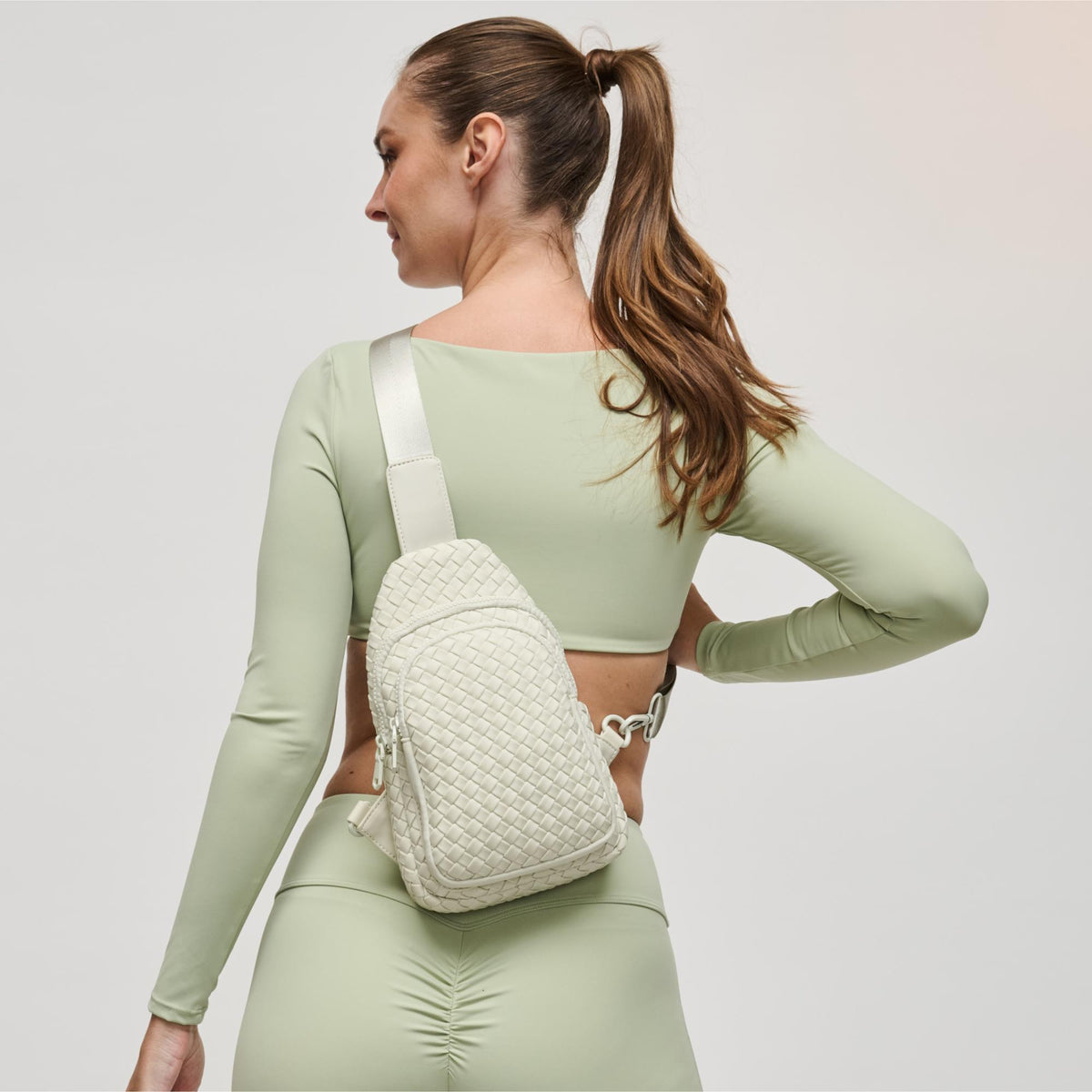 Woman wearing Bone Sol and Selene Beyond The Horizon - Woven Neoprene Sling Backpack 841764109062 View 1 | Bone