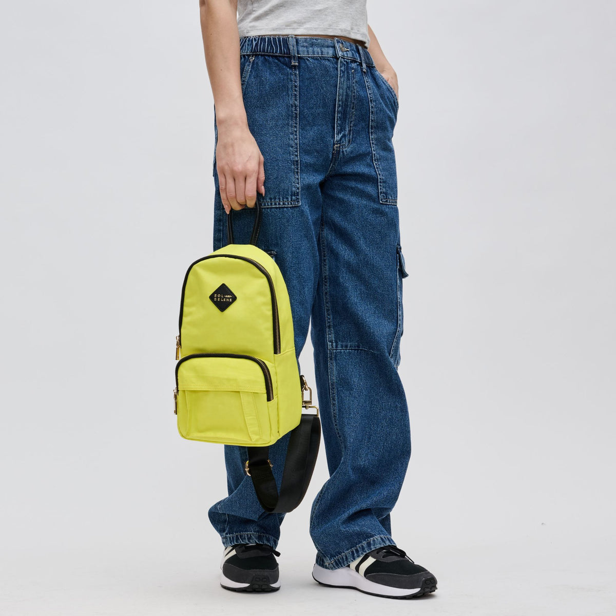 Woman wearing Yellow Sol and Selene Hustle Sling Backpack 841764106566 View 4 | Yellow