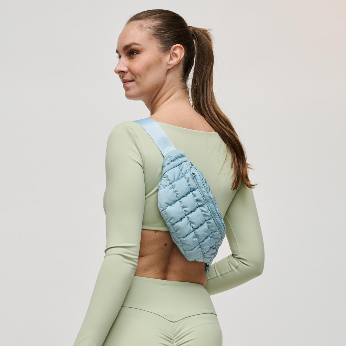 Woman wearing Sky Blue Sol and Selene Resurgence Belt Bag 841764109659 View 3 | Sky Blue