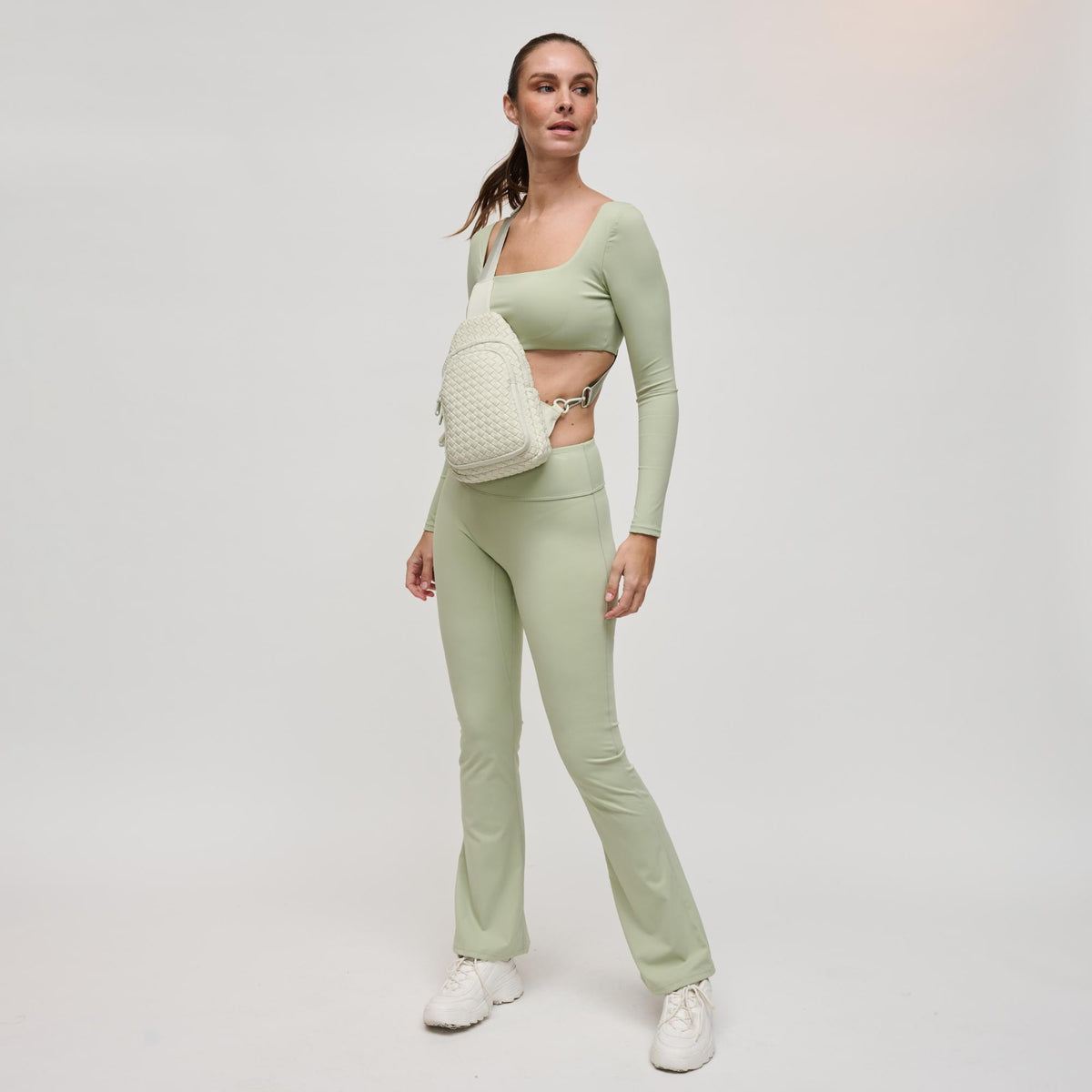 Woman wearing Bone Sol and Selene Beyond The Horizon - Woven Neoprene Sling Backpack 841764109062 View 4 | Bone