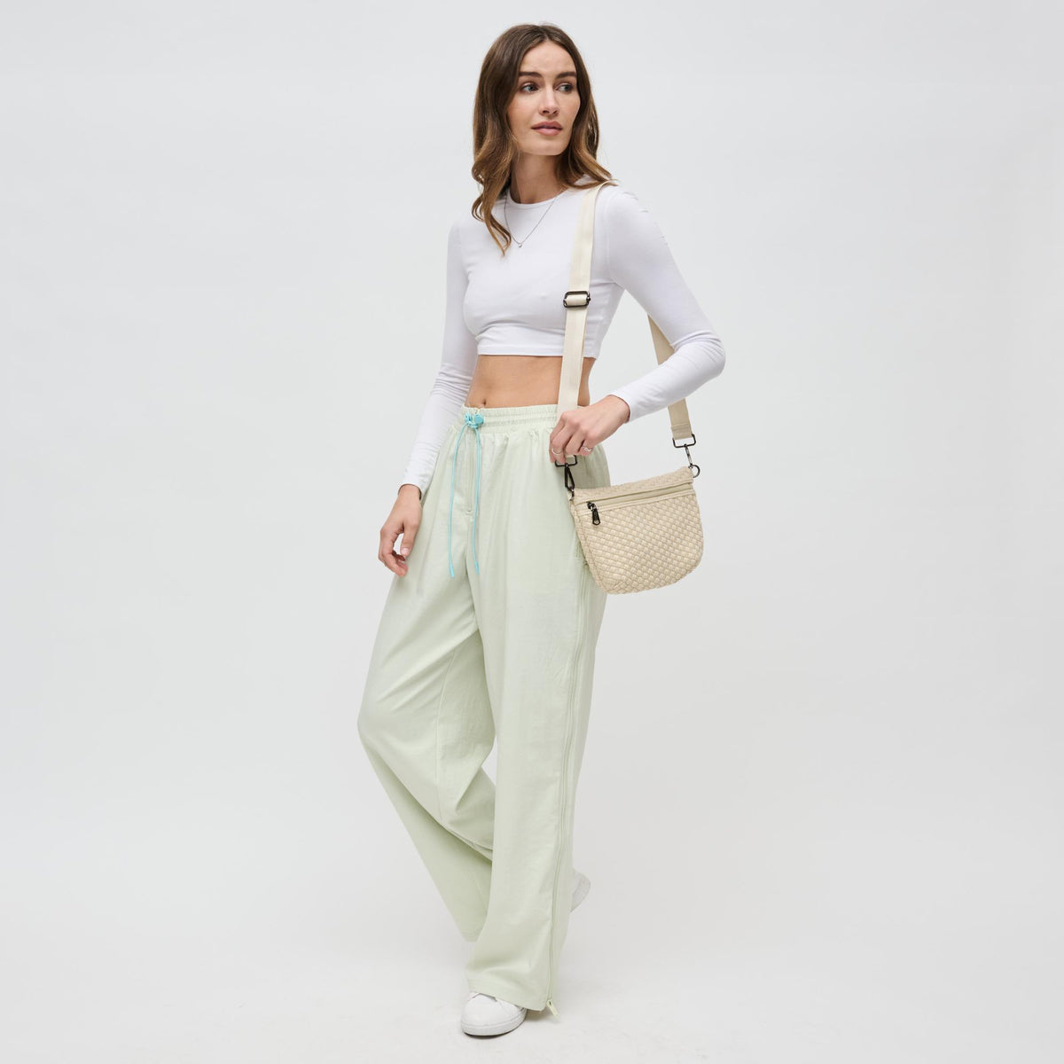 Woman wearing Cream Sol and Selene Ethereal - Woven Neoprene Crossbody 841764110846 View 3 | Cream