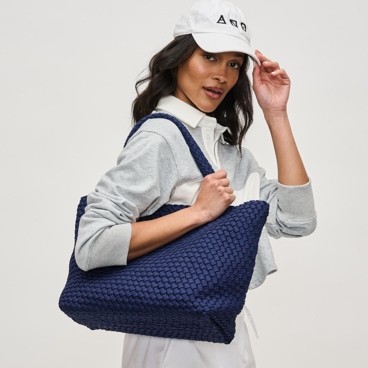 Woman wearing Navy Sol and Selene Sky's The Limit - Medium Laced Up Eco-Edition Tote 841764111614 View 2 | Navy