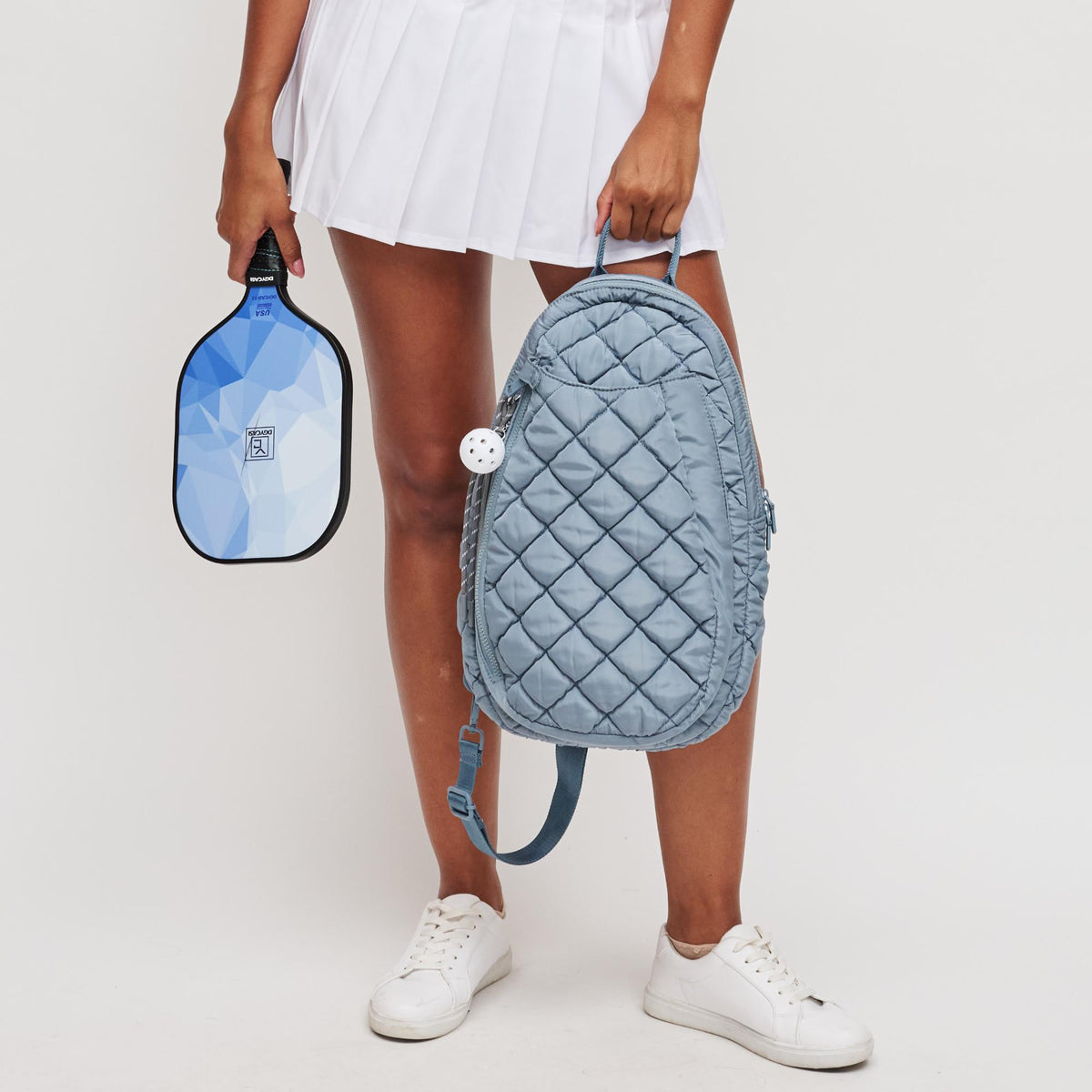 Woman wearing Slate Sky Sol and Selene Match Point - Quilted Puffer Pickleball & Paddle Tennis Sling Backpack 841764112017 View 3 | Slate Sky