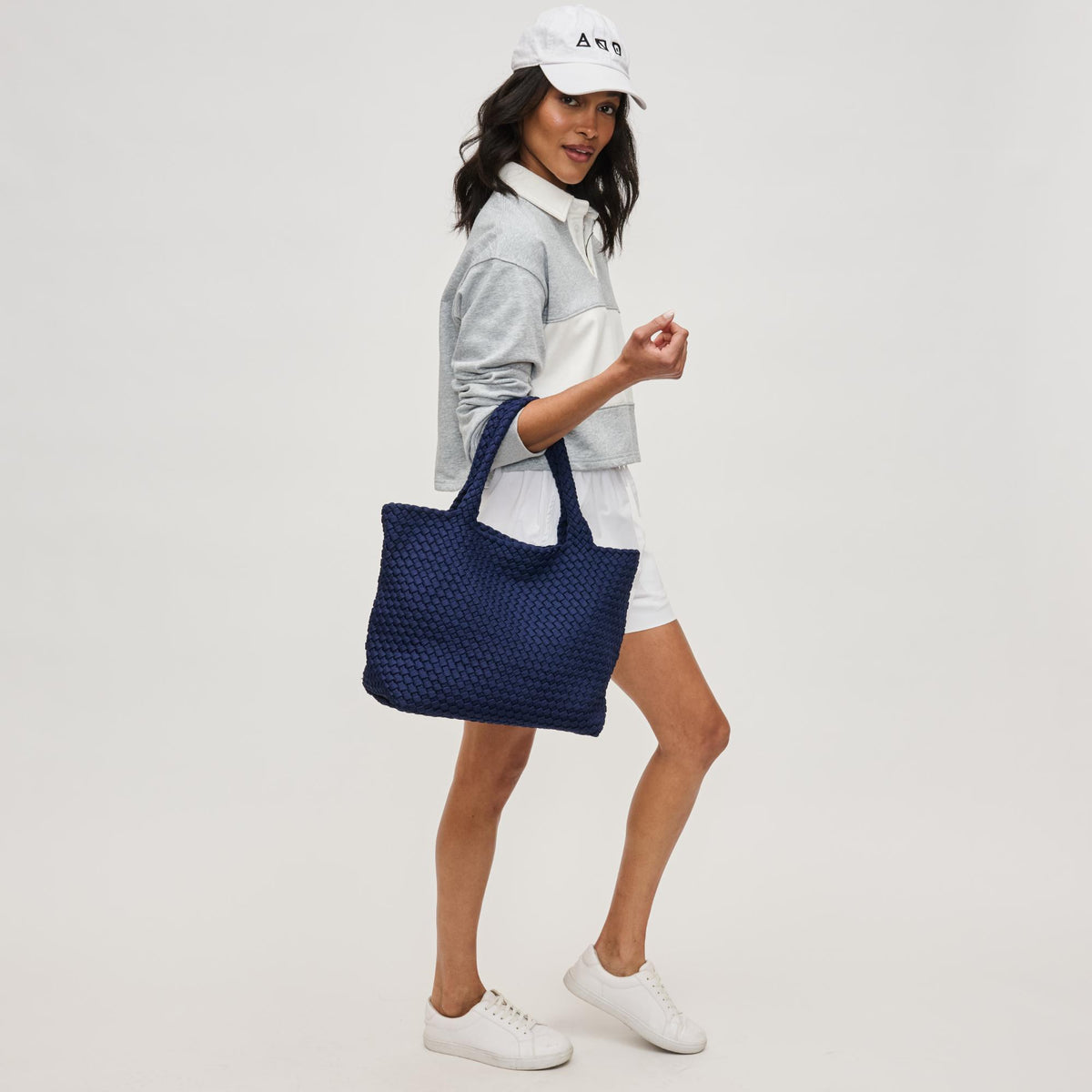 Woman wearing Navy Sol and Selene Sky's The Limit - Medium Laced Up Eco-Edition Tote 841764111614 View 3 | Navy