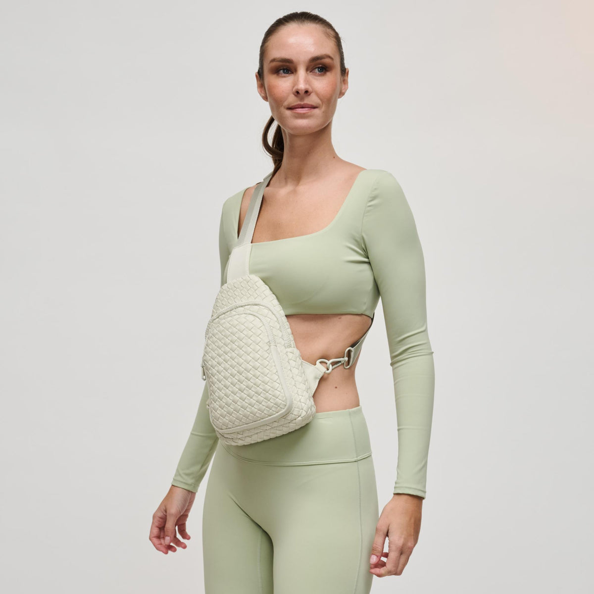 Woman wearing Bone Sol and Selene Beyond The Horizon - Woven Neoprene Sling Backpack 841764109062 View 3 | Bone