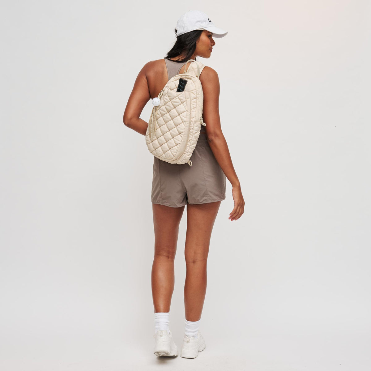 Woman wearing Cream Sol and Selene Match Point - Quilted Puffer Pickleball & Paddle Tennis Sling Backpack 841764111980 View 3 | Cream