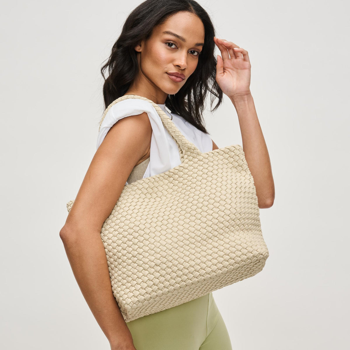 Woman wearing Beige Sol and Selene Sky's The Limit - Medium Laced Up Eco-Edition Tote 841764111584 View 2 | Beige
