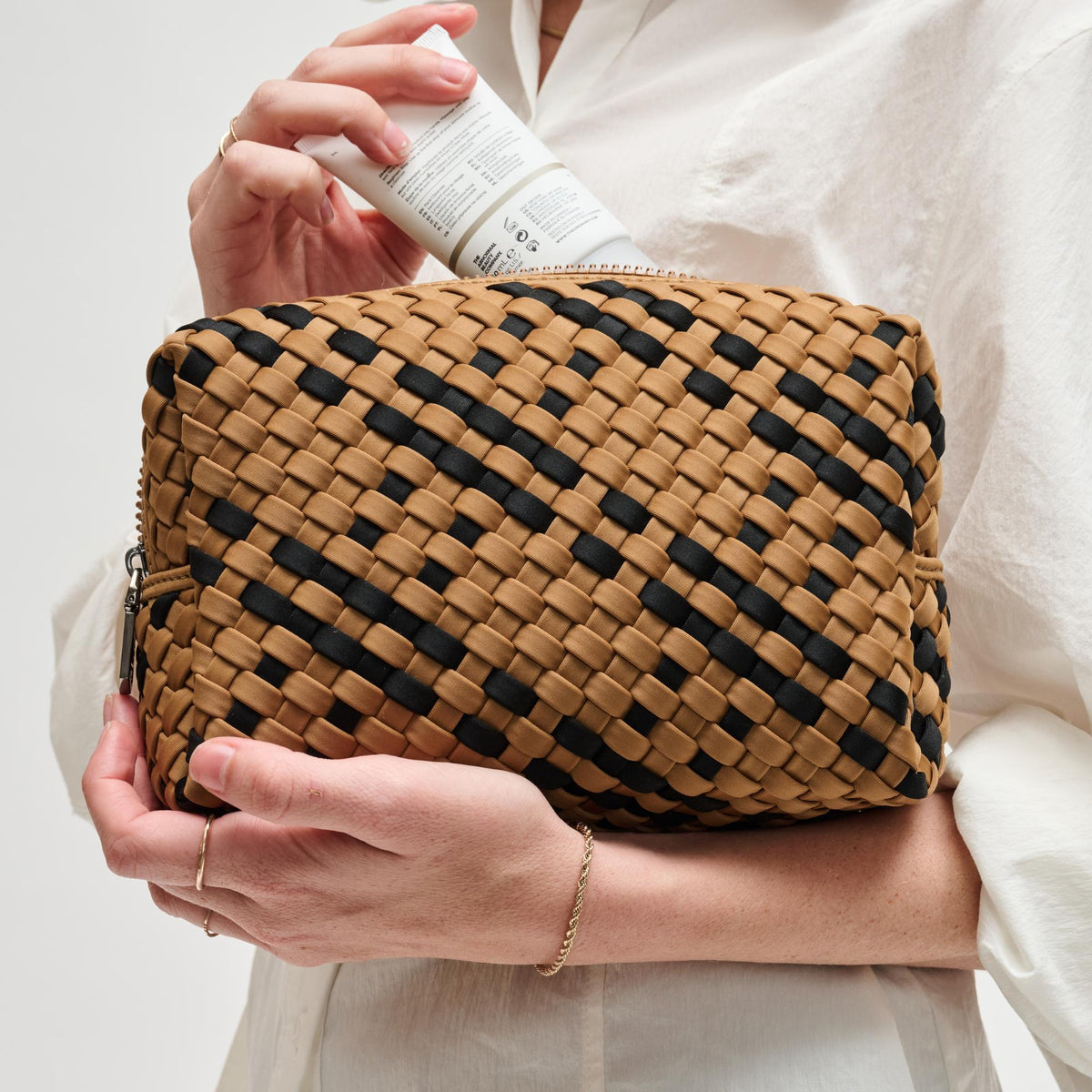 Woman wearing Sand Black Sol and Selene Altitude - Woven Neoprene Cosmetic & Travel Organizer Pouch 841764112482 View 1 | Sand Black