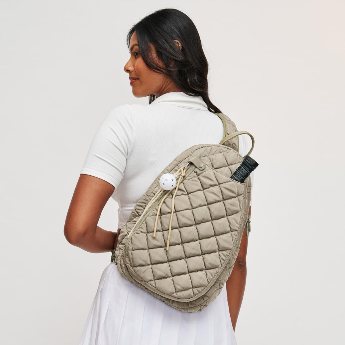 Woman wearing Desert Sage Sol and Selene Match Point - Quilted Puffer Pickleball & Paddle Tennis Sling Backpack 841764112000 View 2 | Desert Sage