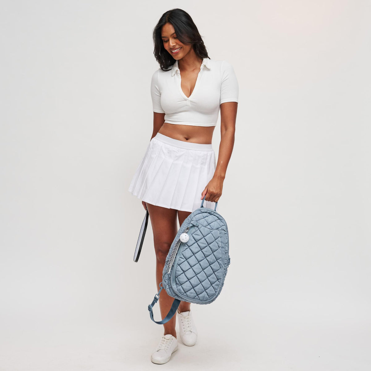 Woman wearing Slate Sky Sol and Selene Match Point - Quilted Puffer Pickleball & Paddle Tennis Sling Backpack 841764112017 View 4 | Slate Sky