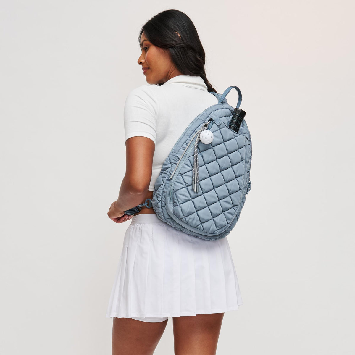 Woman wearing Slate Sky Sol and Selene Match Point - Quilted Puffer Pickleball & Paddle Tennis Sling Backpack 841764112017 View 2 | Slate Sky