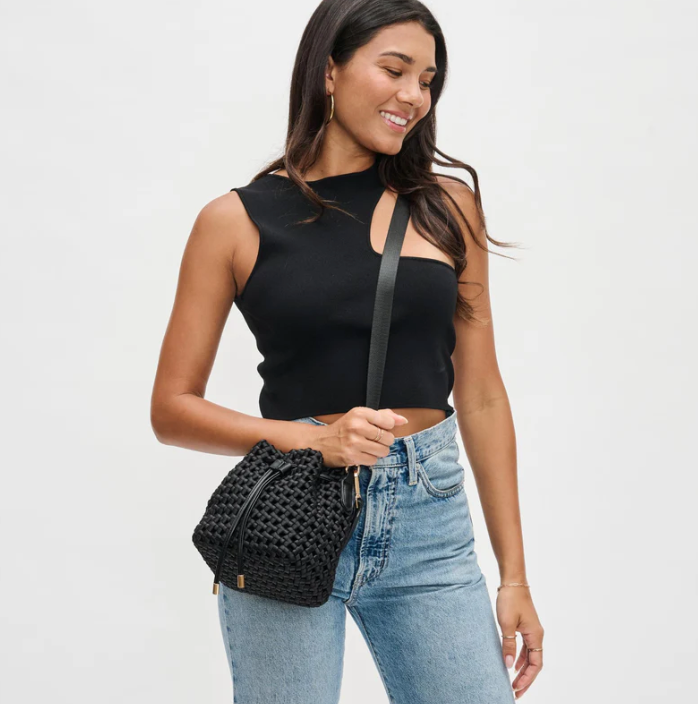 model wearing a black crossbody bag