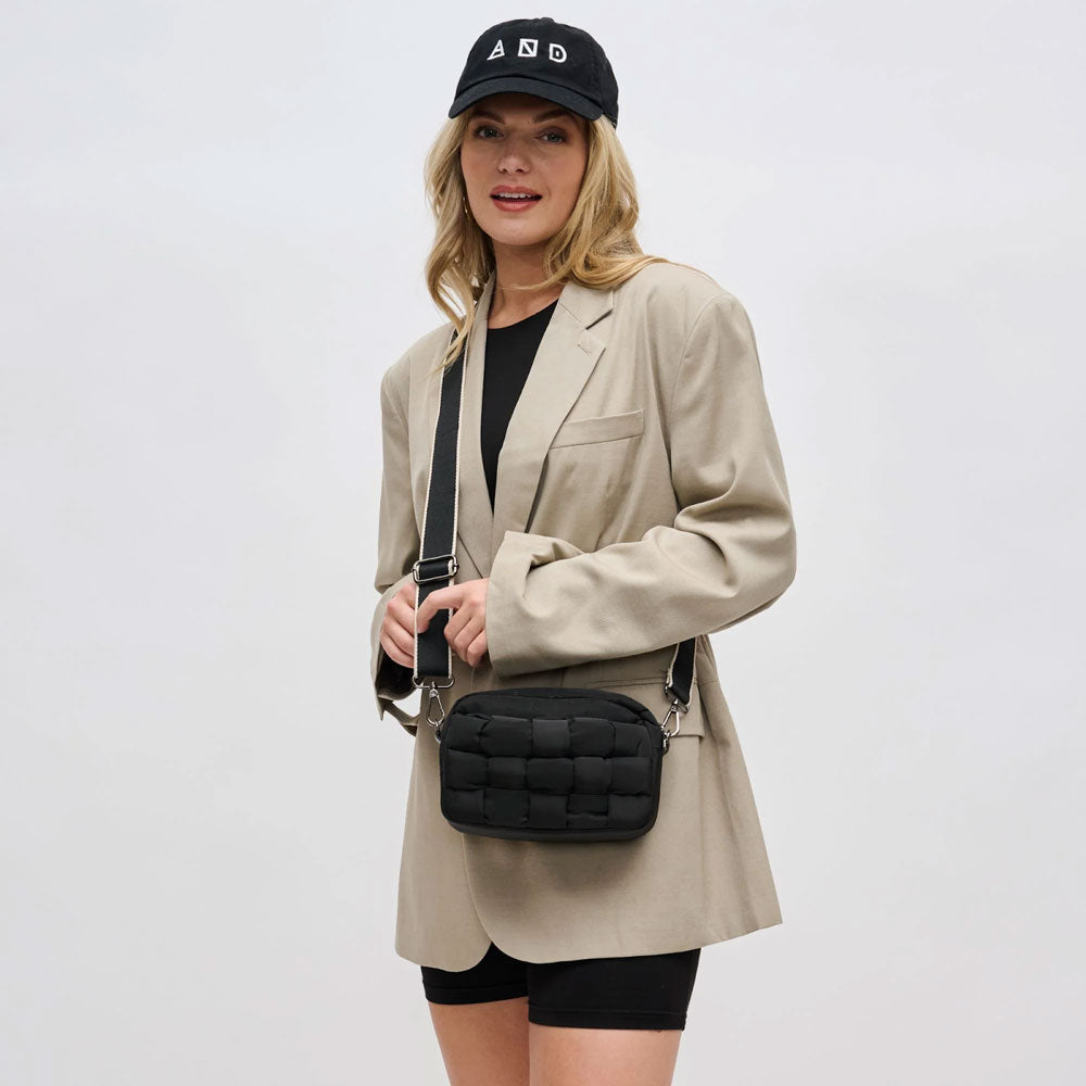 a model in a blazer with a black crossbody bag