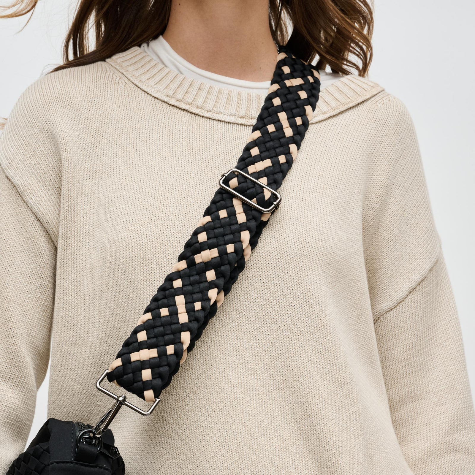 woman wearing a bag with a multicolored crossbody strap