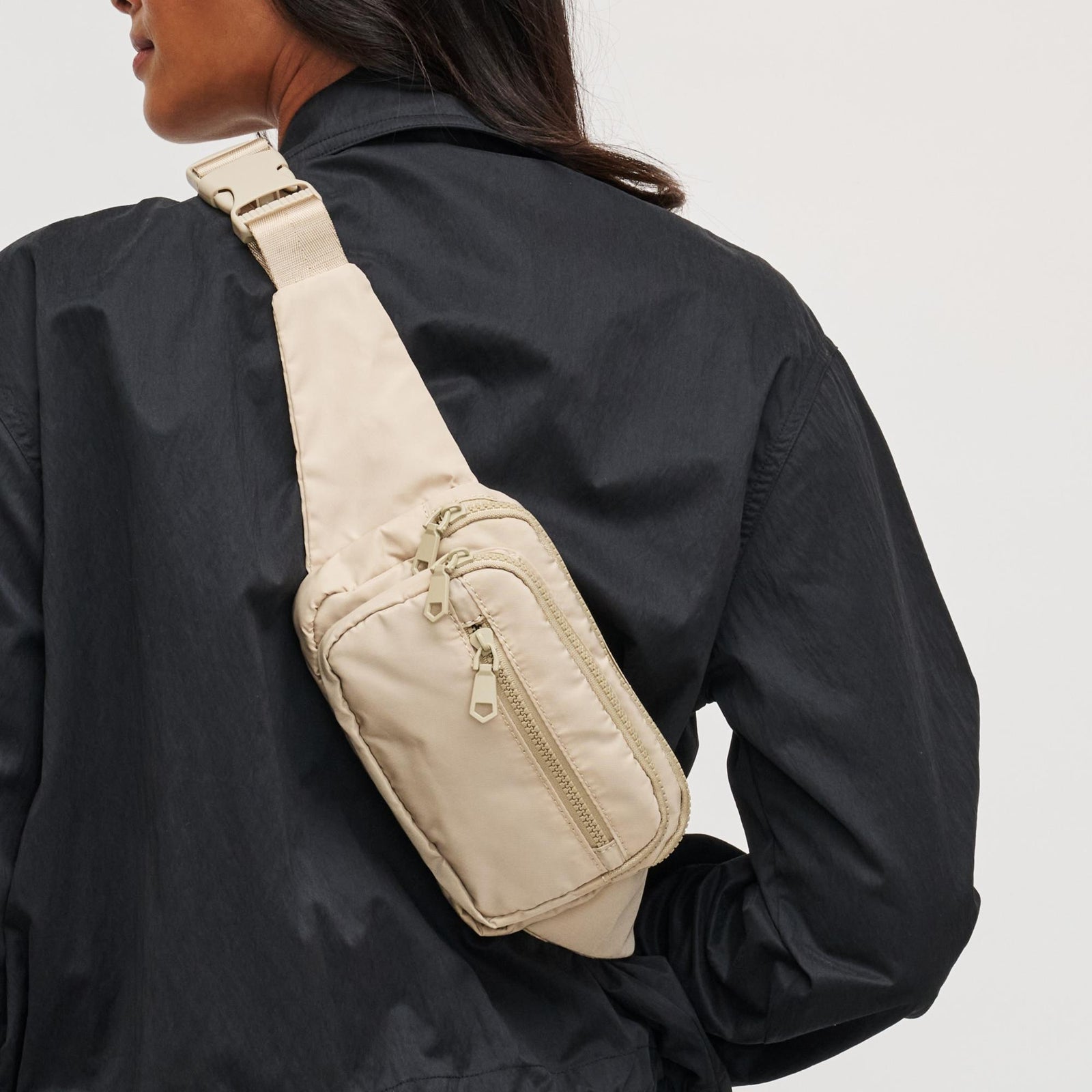 woman with a nude belt bag on her back