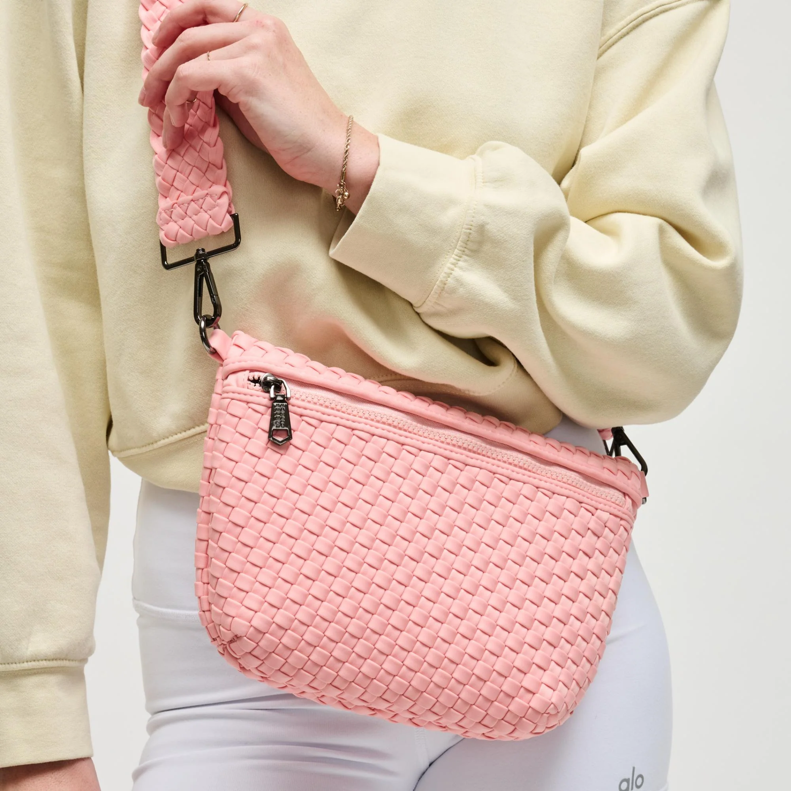 Woman wearing a pink crossbody purse