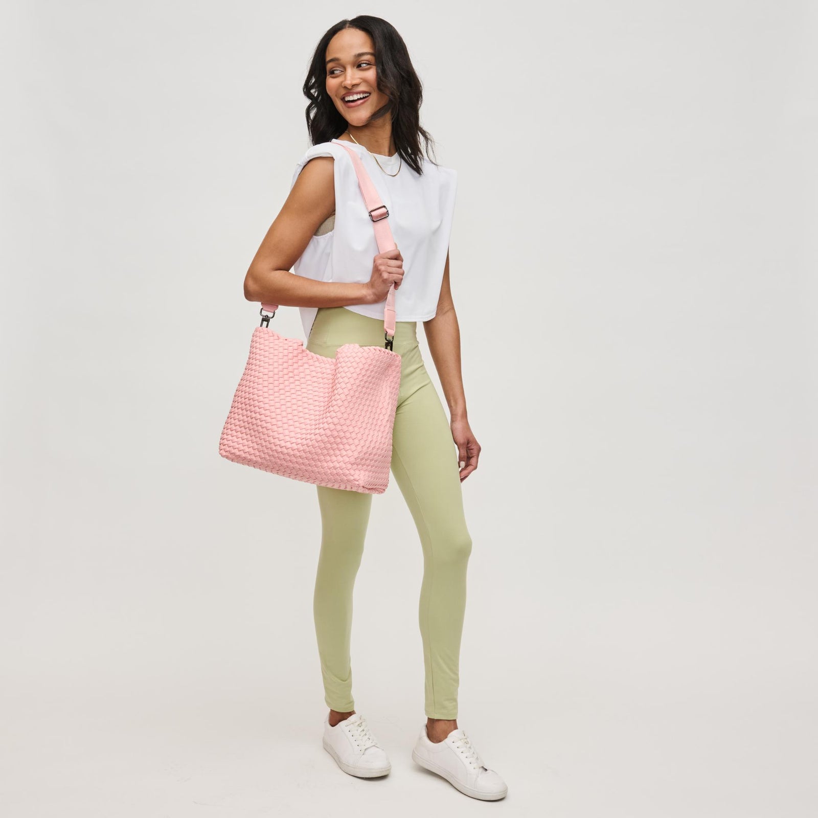 pink yoga mat bag on a woman’s back