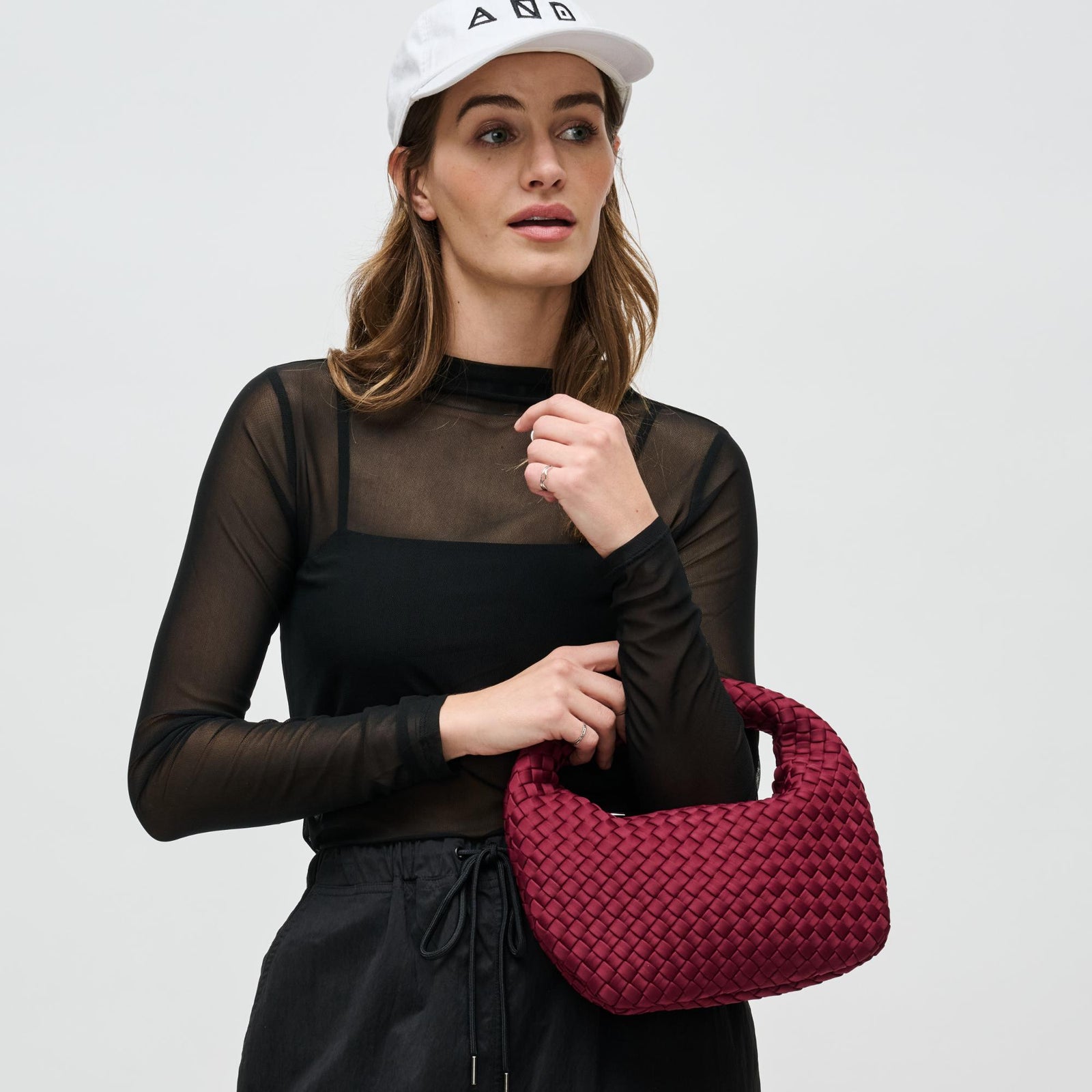 woman with a red mini clutch on her arm