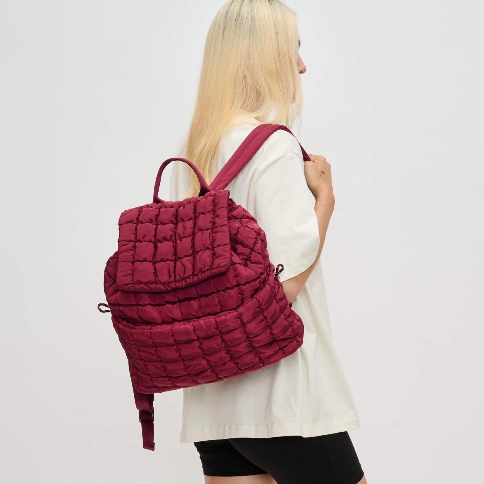 woman with a red puffer backpack on her back