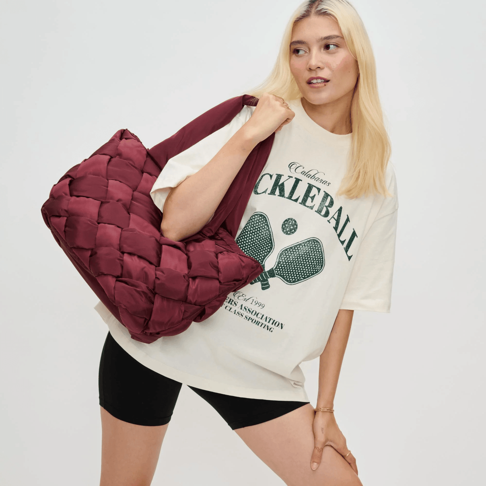Woman holding a red tote with practical handbag features