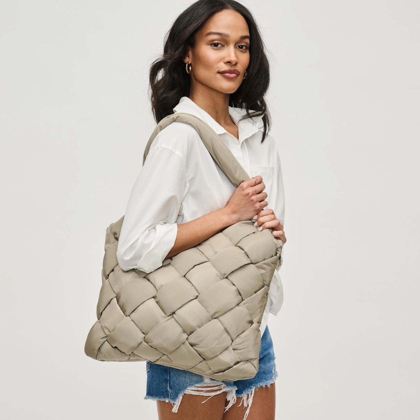 A sage tote handbag gift for mom on a woman’s shoulder