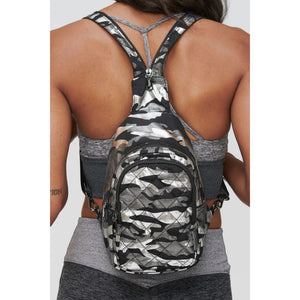 Woman wearing Silver Metallic Camo Sol and Selene On The Run Sling Backpack 841764104432 View 2 | Silver Metallic Camo